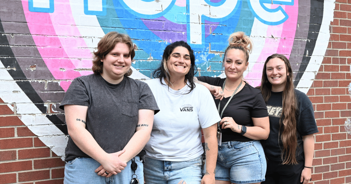 Class 1 Teaching Staff standing together in front of the Hope mural