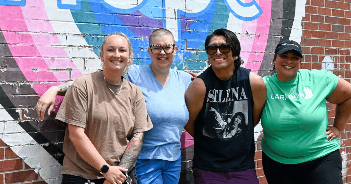 Class 1 Teaching Staff standing together in front of the Hope mural