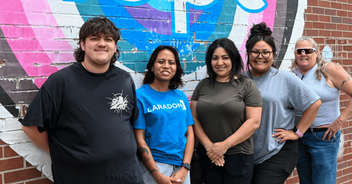 Class 1 Teaching Staff standing together in front of the Hope mural